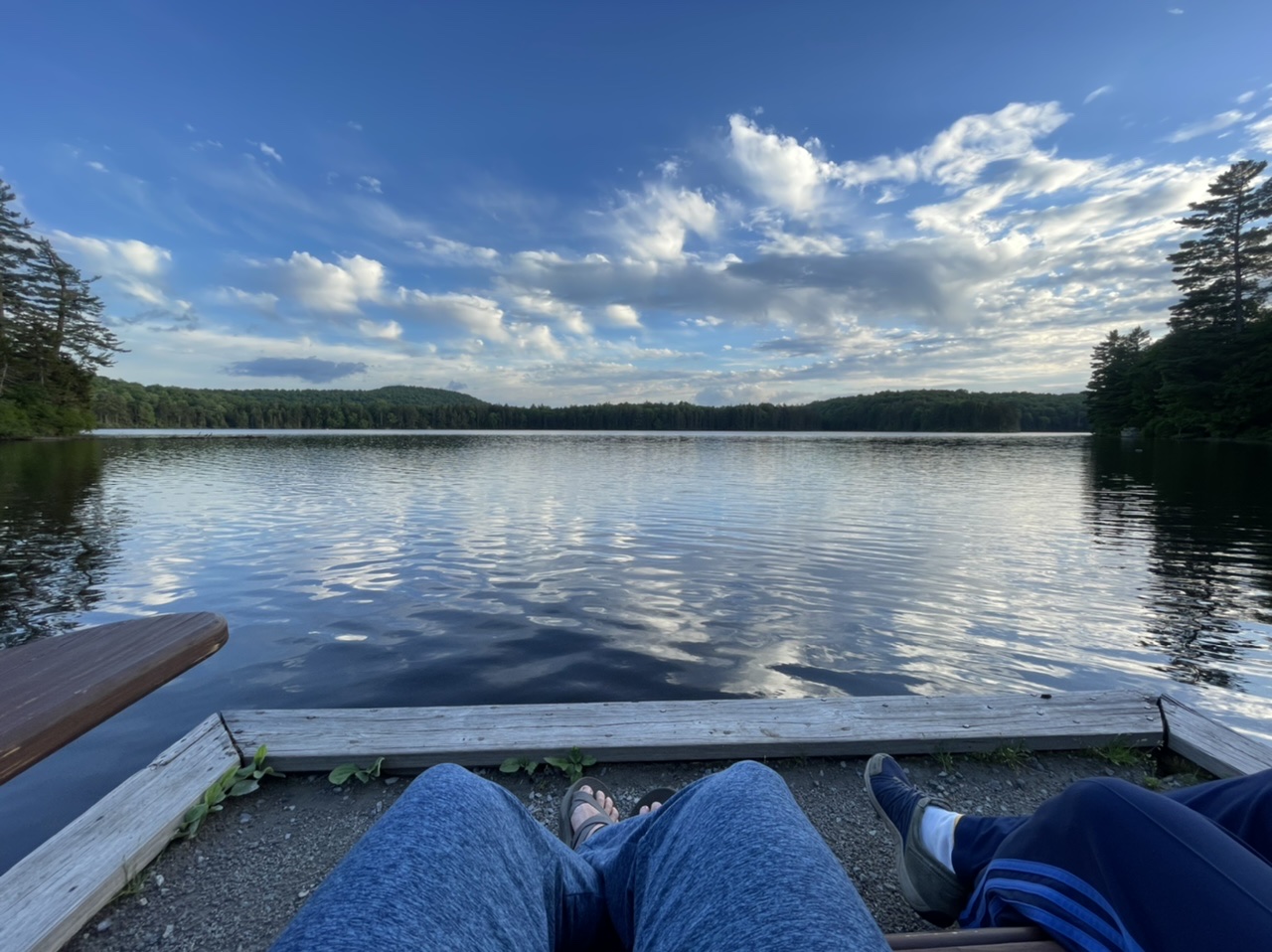 Sitting in a super comfy double Adirondack chair at the end of a dock