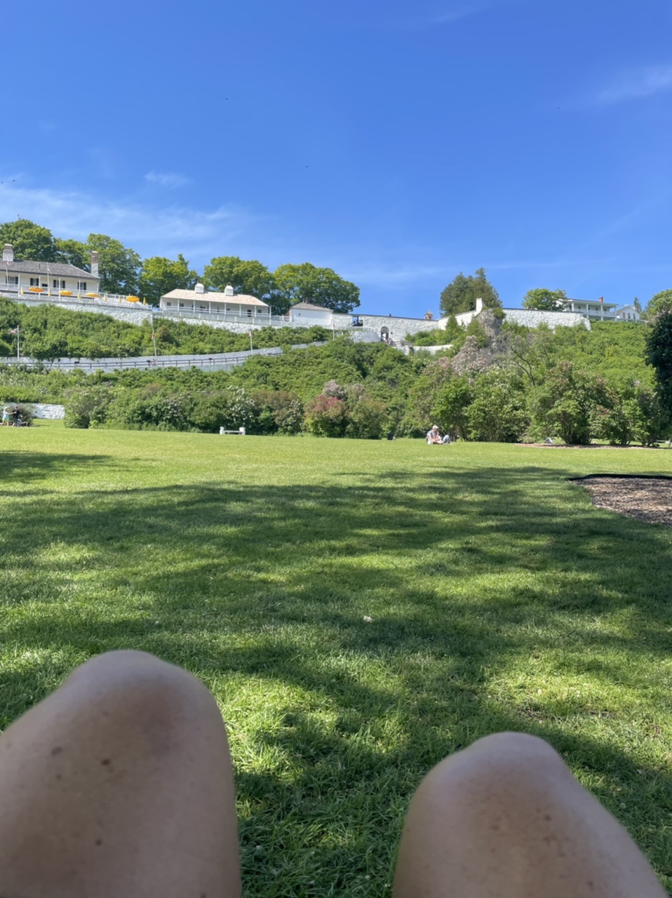 Relaxing in the park, looking up at Fort Mackinac