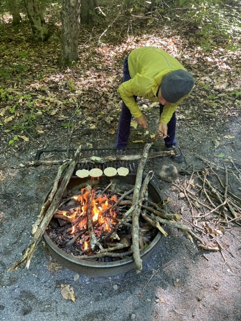 Toasting English muffins over a fire we built with wood from near our site