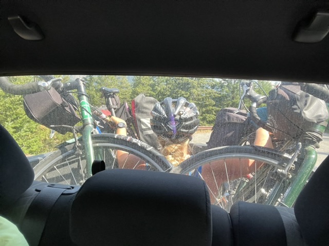 MJ riding in back with the bikes as we got through the gravelly road