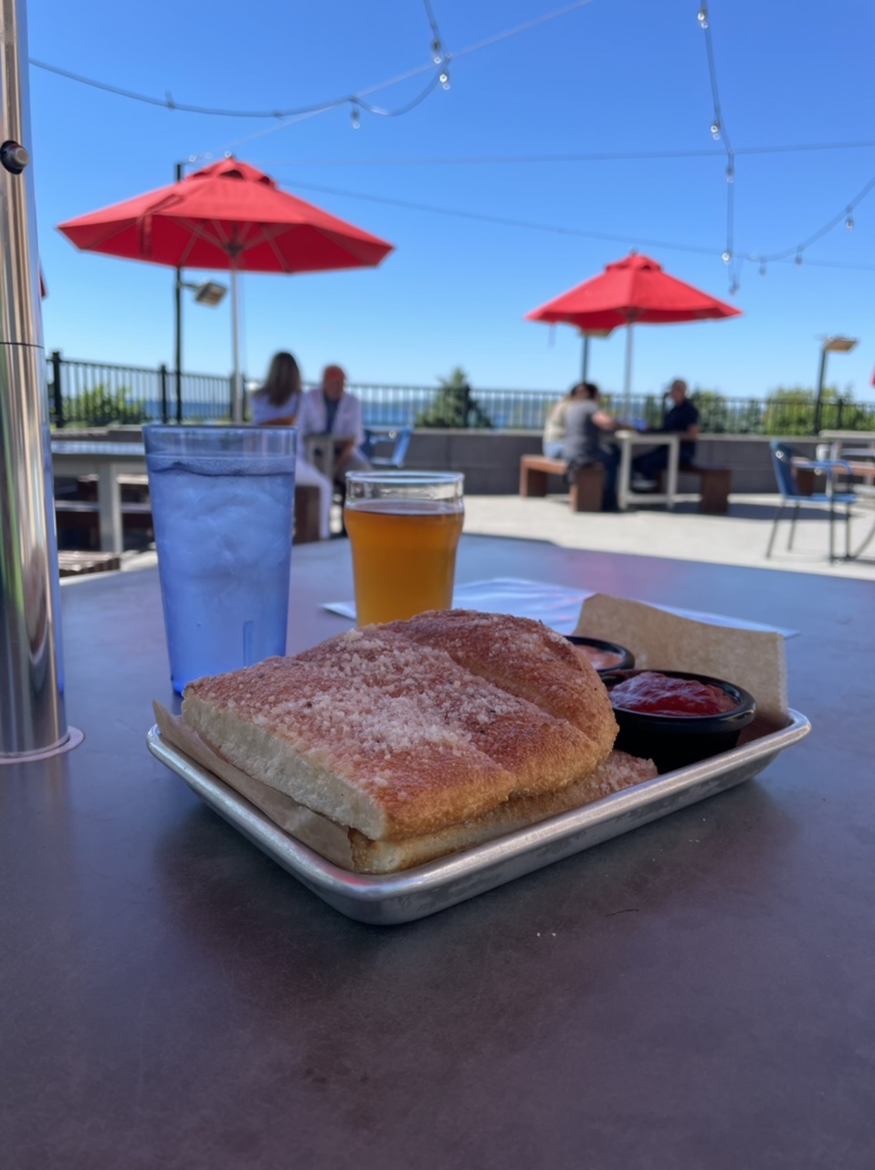 Near end of day local brewery break with a mini rhubarb beer and cheesy breadsticks